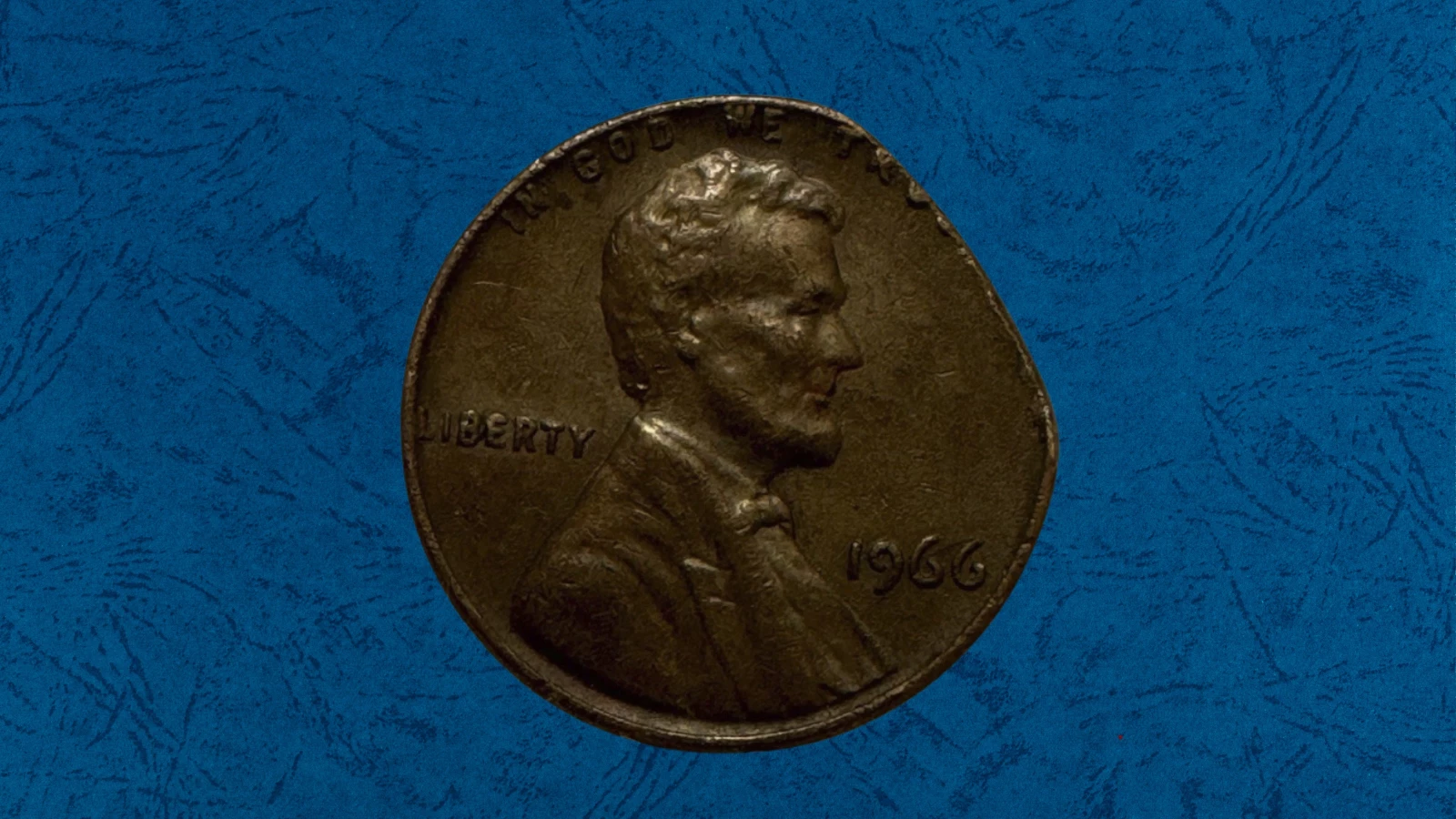 1966 penny clipped planchet error showing curved crescent clip missing from edge with Blakesley effect