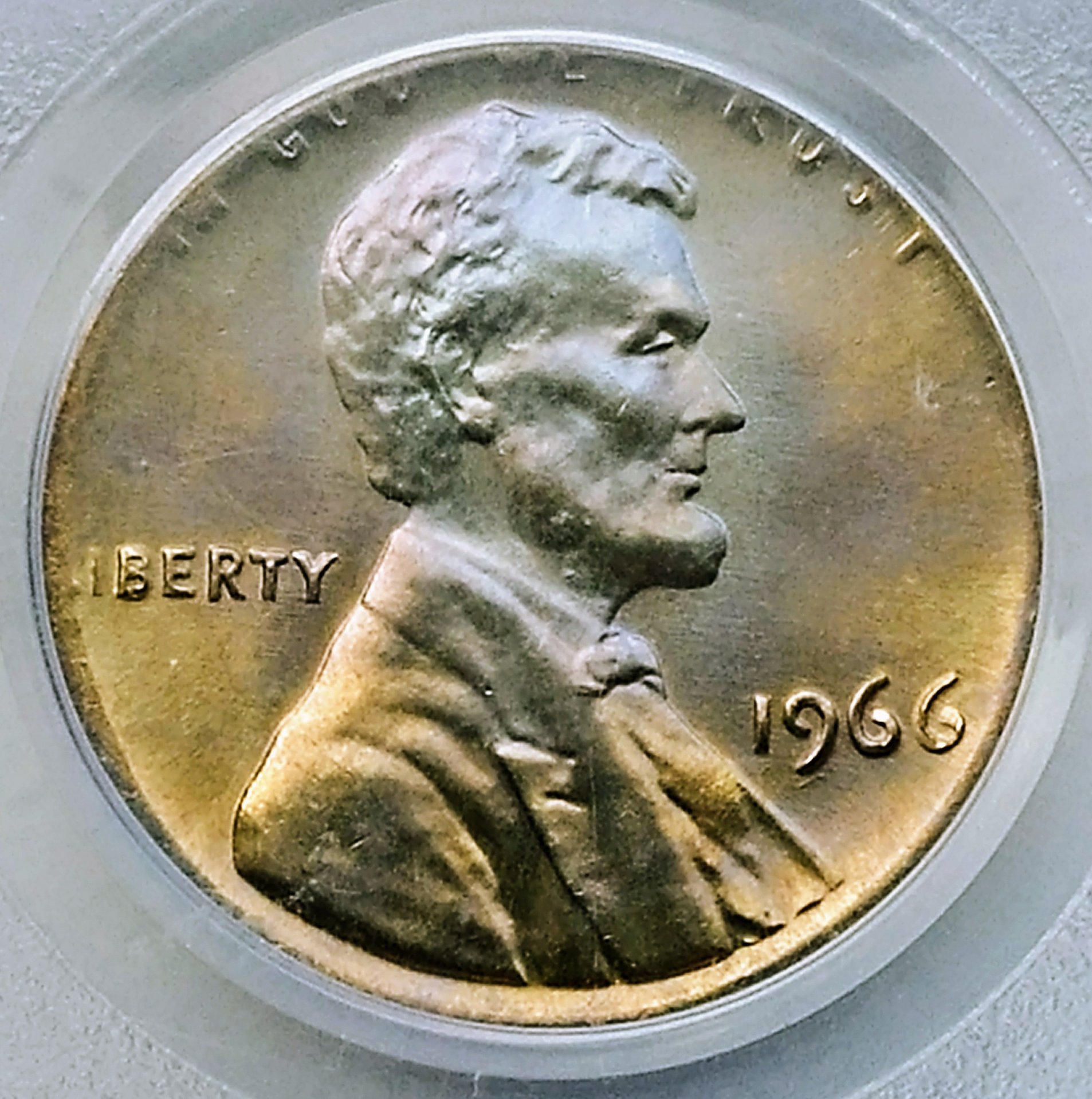 1966 penny struck on dime planchet showing silver-gray color smaller diameter and clipped peripheral design elements